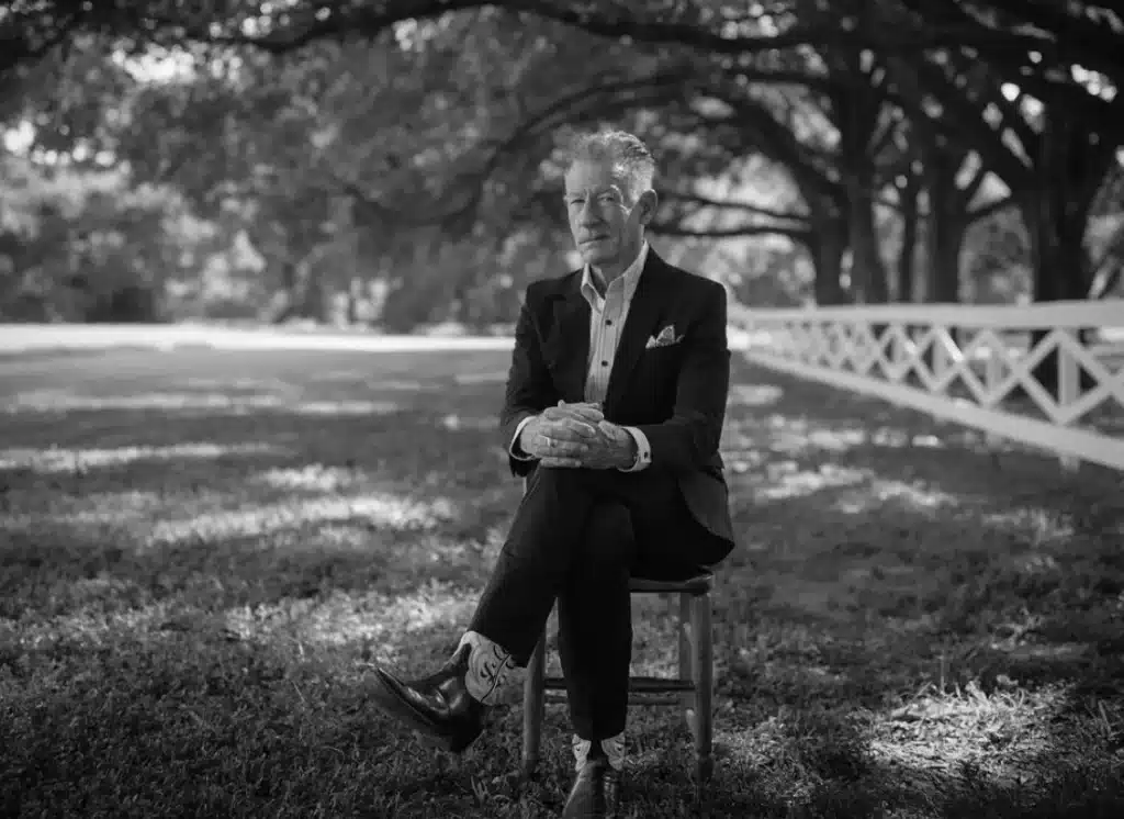 Lyle Lovett seated outdoors ahead of his St. Louis 2025 concert tour stop